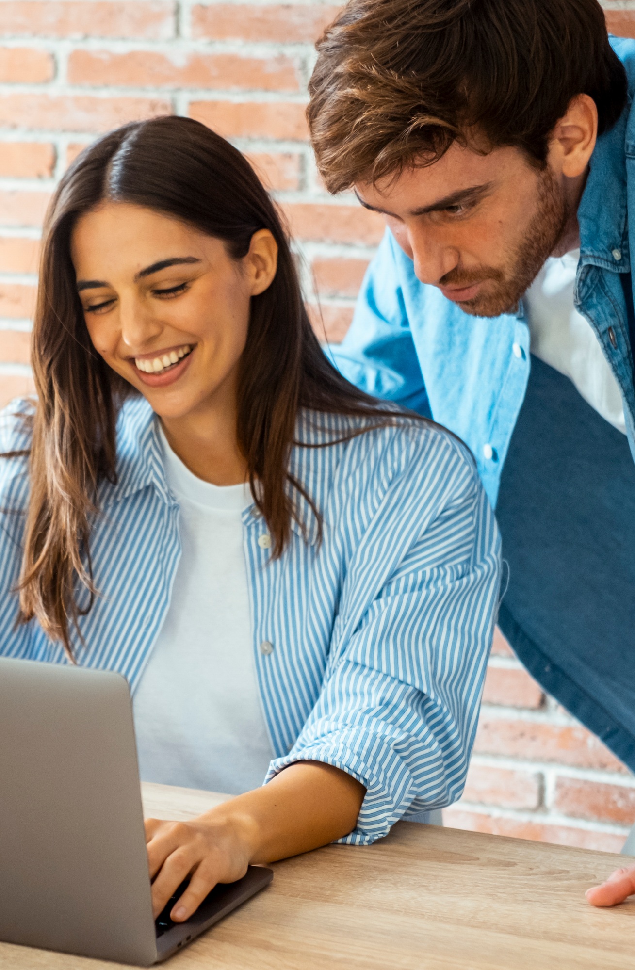Happy young couple having loving relationships smile at home desk shopping online in online store